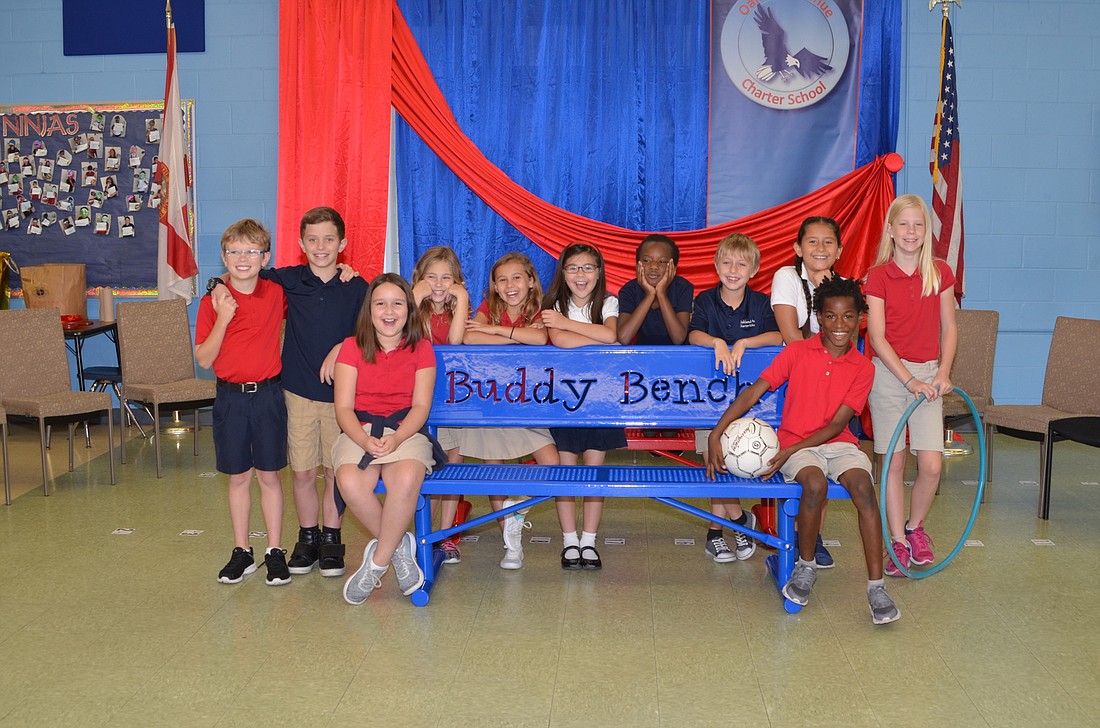 Third-graders check out the new Buddy Benches that will be installed near the playground.