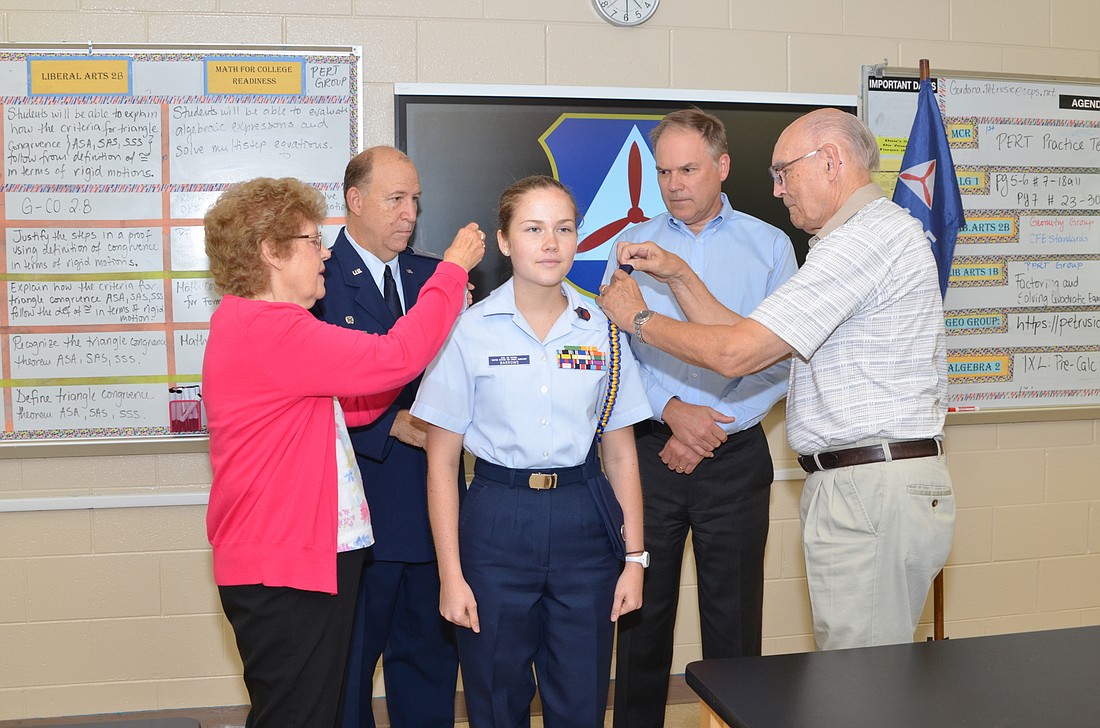 Second Lt. Kendall Barrows asked her grandparents, Mary Barrows, left, and Dave Barrows, right, to pin on her epaulets. In back are Capt. BrianA. Collins, squadron commander, left, and her father, Greg Barrows.
