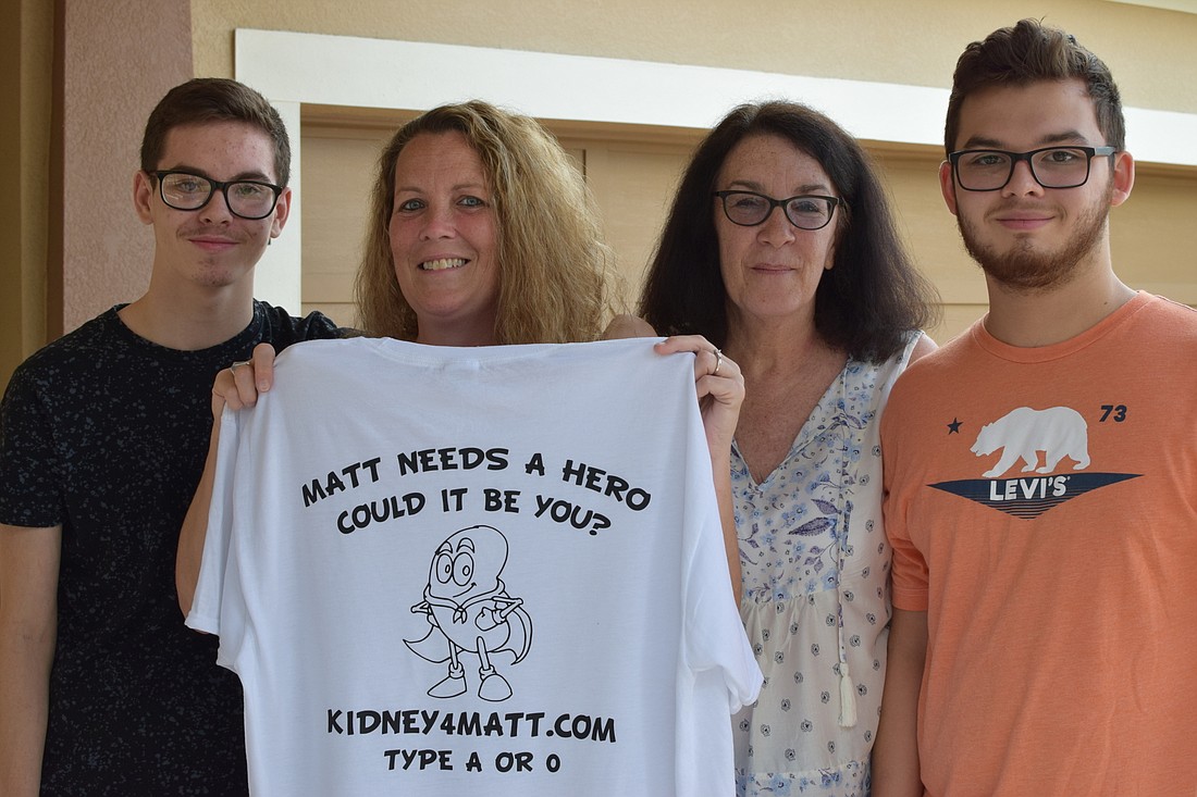 Matthew Bustamante, LisaÂ Largue, Barbara Downing and Miguel Bustamante display a shirt they designed to spread awareness of Matthew&#39;s need for a kidney transplant.
