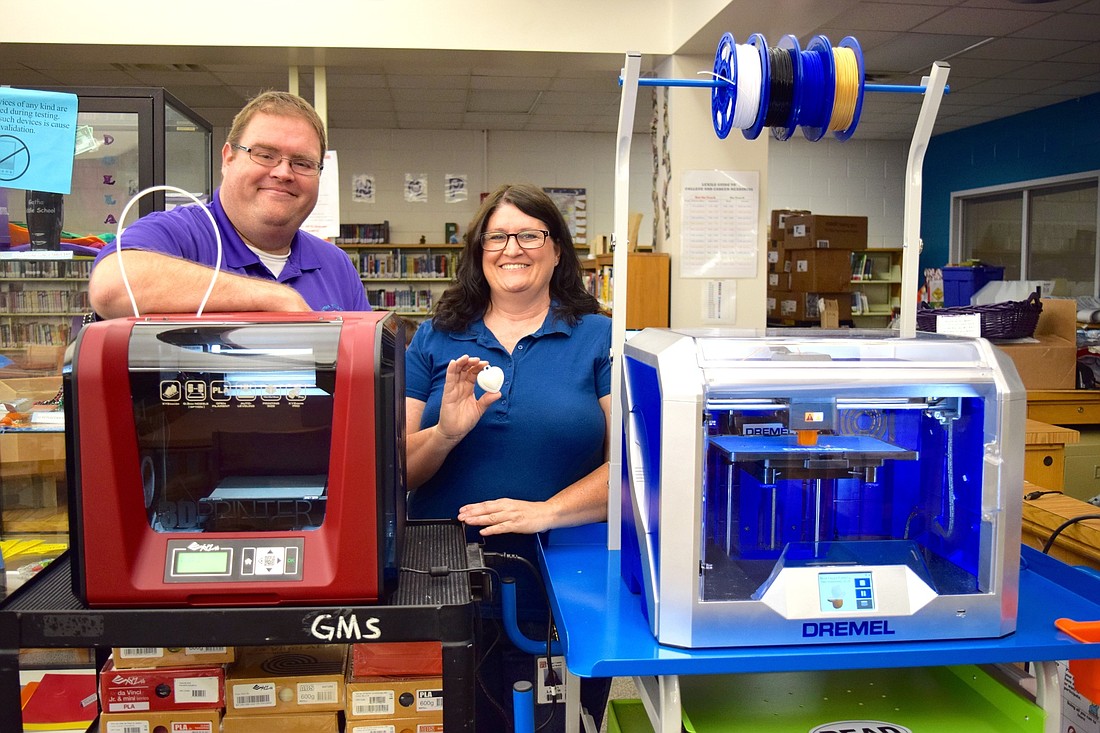 Gotha Middle Assistant Principal Matthew Owens and media specialist Trina Labaw are excited to introduce the new 3D printers to their students.