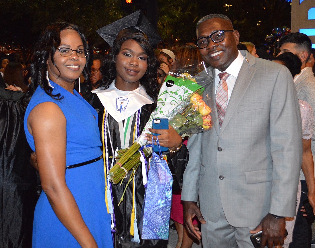 Queeny JosÃ© and her parents, Marielle JosÃ©-Giraud and Jean Austa JosÃ©, celebrate at her graduation from Olympia High School.