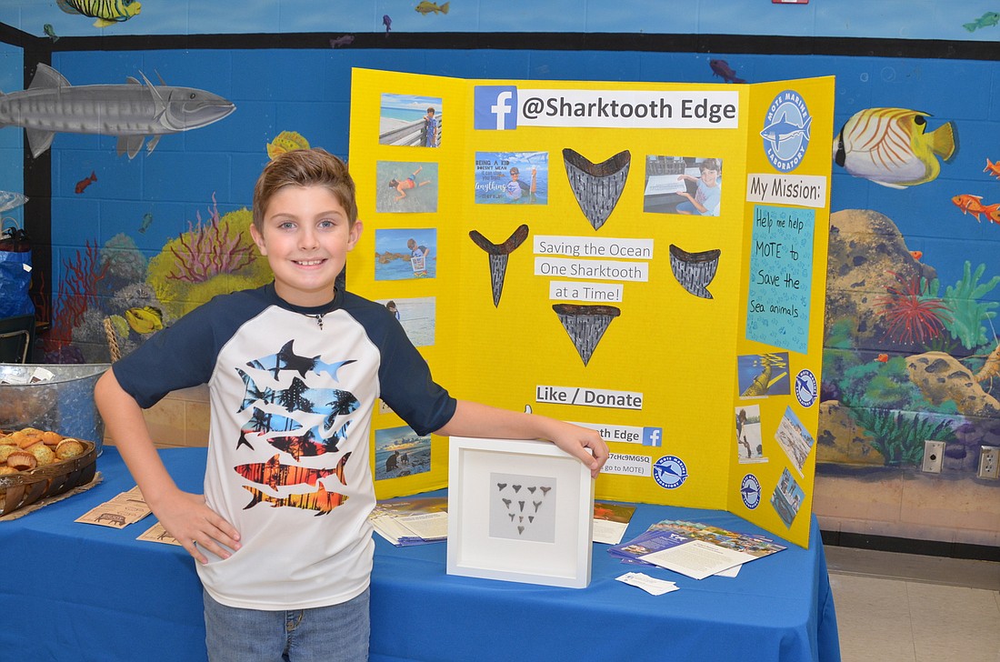 Nine-year-old Edgy Glum set up an information booth at Thornebrooke Elementary Schoolâ€™s open house to inform parents and students of the effects of red tide on sea creatures.
