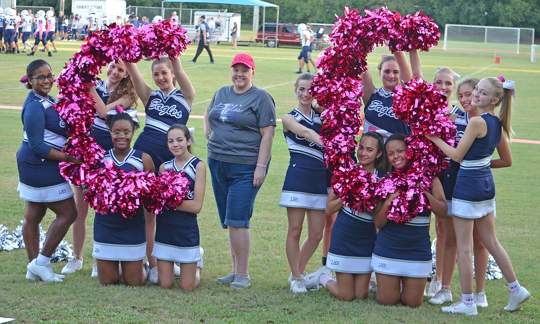 The cheerleaders at Legacy High have been alongside their coach, Christine Giddens, in her fight against breast cancer.