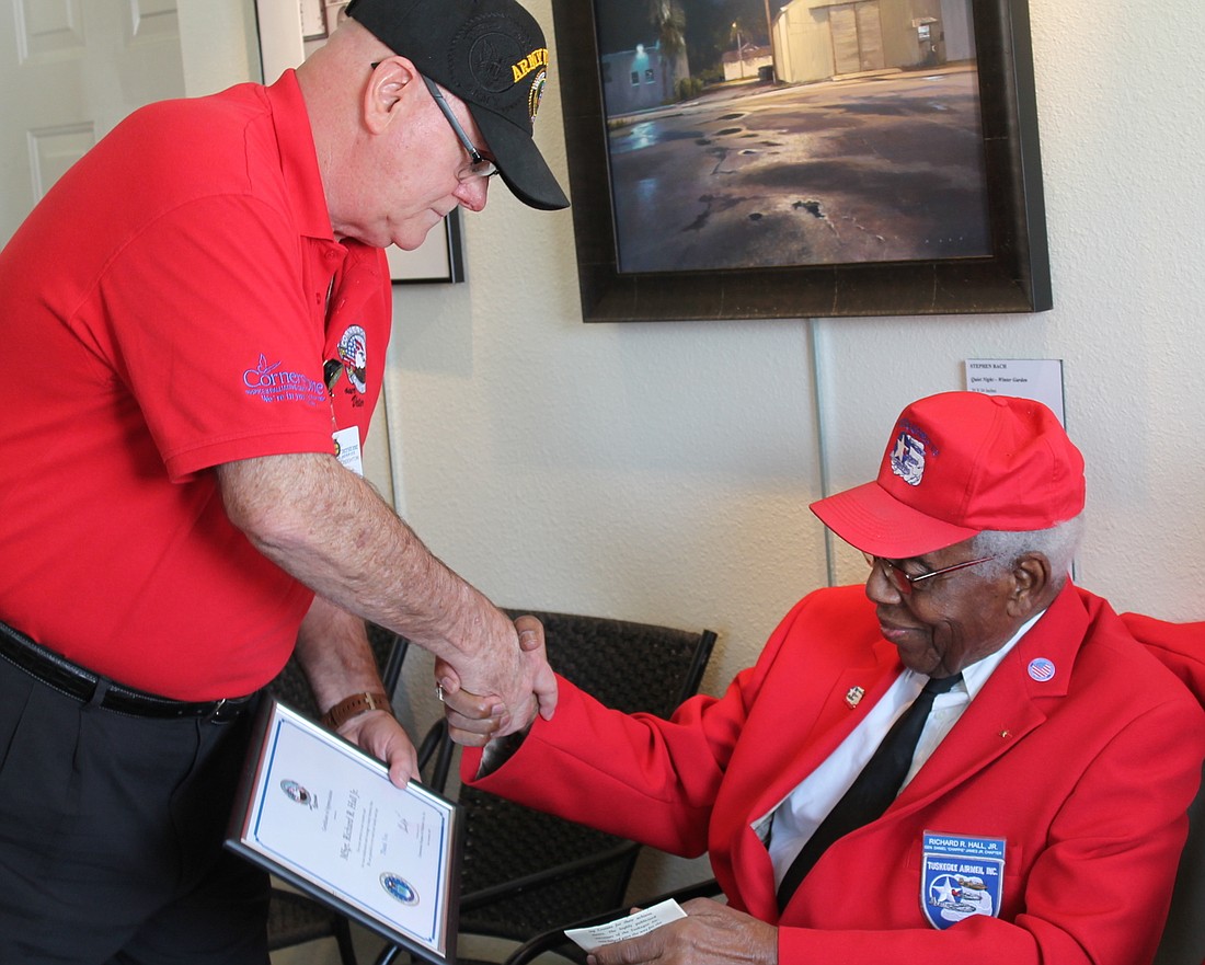 John Creighton, left, dedicates his time to honoring veterans, such as Richard Hall Jr., of Winter Park, a retired Air Force chief master sergeant and Tuskegee Airman.