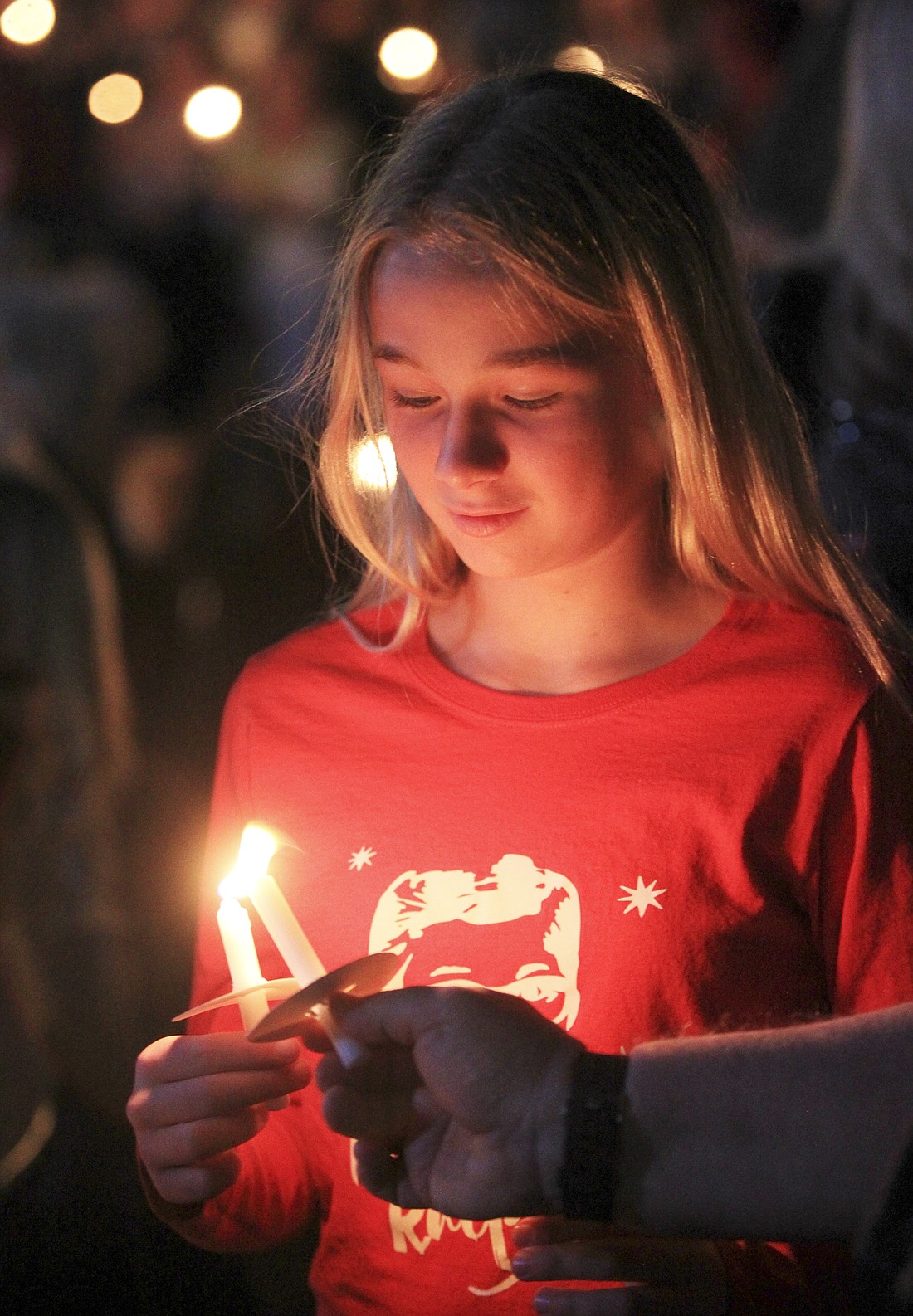 West Orange Times & Observer Photo Avery Bangsund helps light a