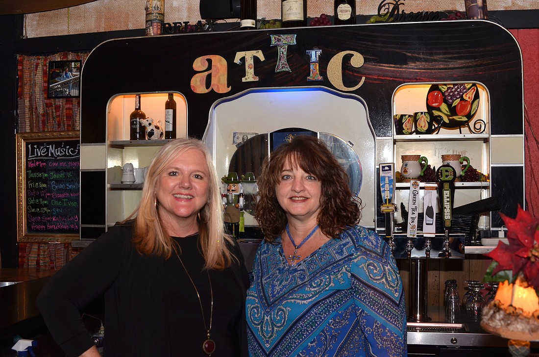 Lori Gibson, left, is selling The Attic Door to Laurie Tarter, right, and Kevin Tarter, owners of Chefâ€™s Table and The Tasting Room.