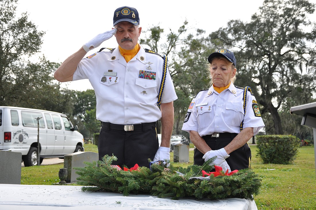 Martin Cook and Laura Reagen of the American Legion Post 286 Honor Guard paid their respects before placing wreaths during the ceremony.