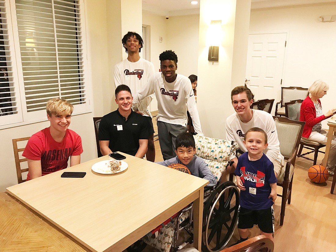 Orangewood basketball players brought food and spent some quality time with families at the Quantum House.