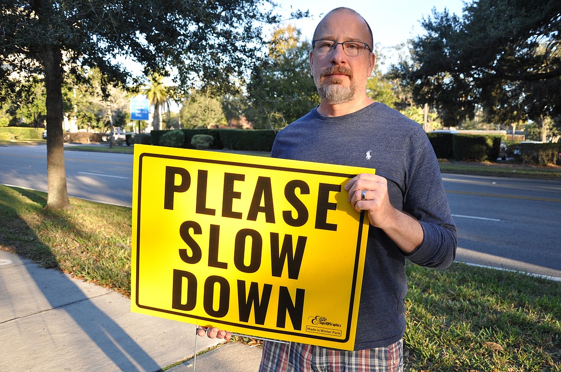Winter Park resident Garrick Spears and his neighbors are displaying signs in hopes of making Orange Avenue safer.