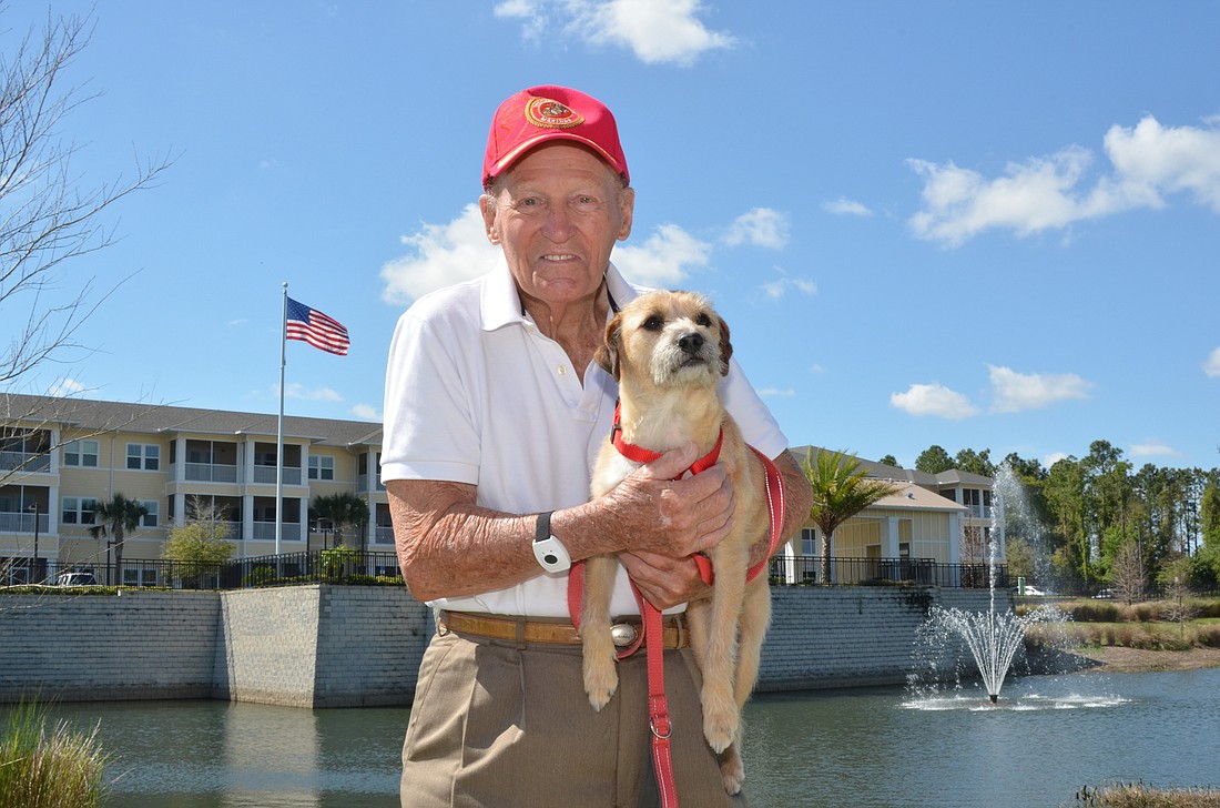 Fred Jennings and his dog, Buddy, walk laps around the lake and fitness path at Sonata West, in Winter Garden, every day.