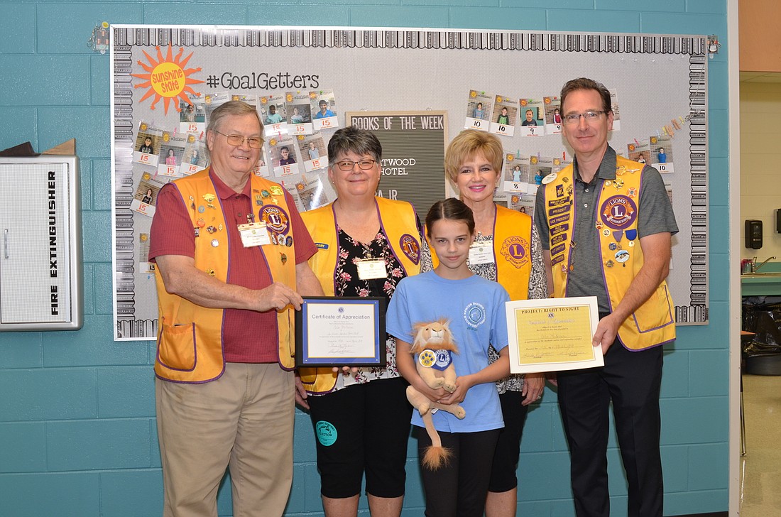 Members of the Winter Garden Lions Club recognized Chloe McCarron for collecting two boxes full of eyeglasses.