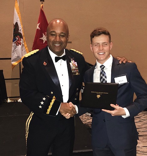 Lt. Gen. Darryl A. Williams, left, presents Greyson Everidge with his appointment to the United States Military Academy at West Point.