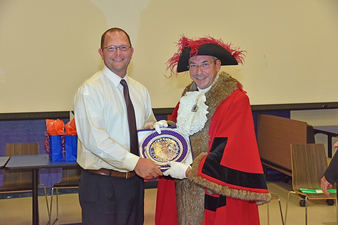 Band Director Kenneth Boyd accepted a gift from the British dignitary in September 2018. Photo by Thomas Lightbody.