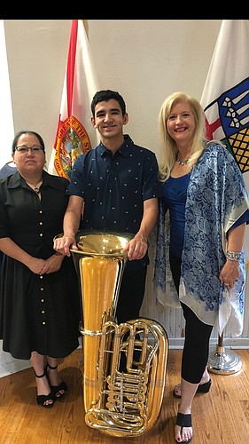L.T. Sipek and his mother, Lori Sipek, left, were surprised with two college scholarships at a recent Windermere Town Council meeting. At right is Anne McDonough, who presented the scholarship from Windermere Arts.