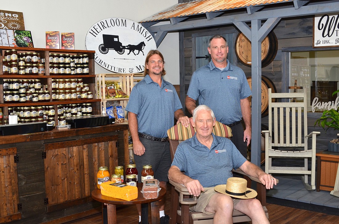 John Zahradnik Sr., front, John Zahradnik Jr., left, and Frank Beardsley have opened Heirloom Amish Furniture in downtown Winter Garden.