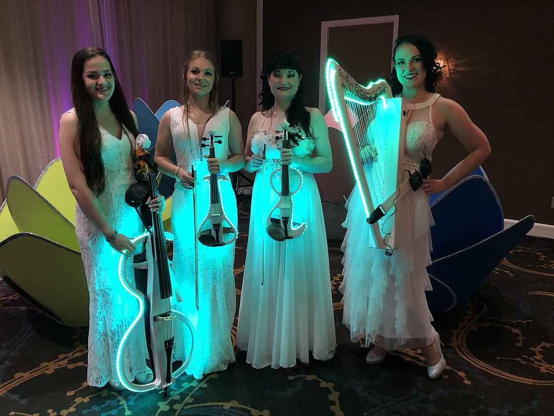 Yamilet Trujillo, Lexy Parsons, Michelle Jones and Madison Harding are just four of the members who play in Fretless Rock; they are known for the light-up instruments they play in performances.