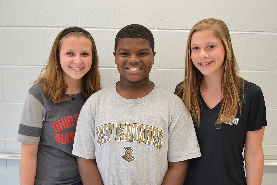 Student Council members Jordan Kocarek (left), Woody Omega and Mary Sosebee each played a role during the naturalization ceremonies held at the school.