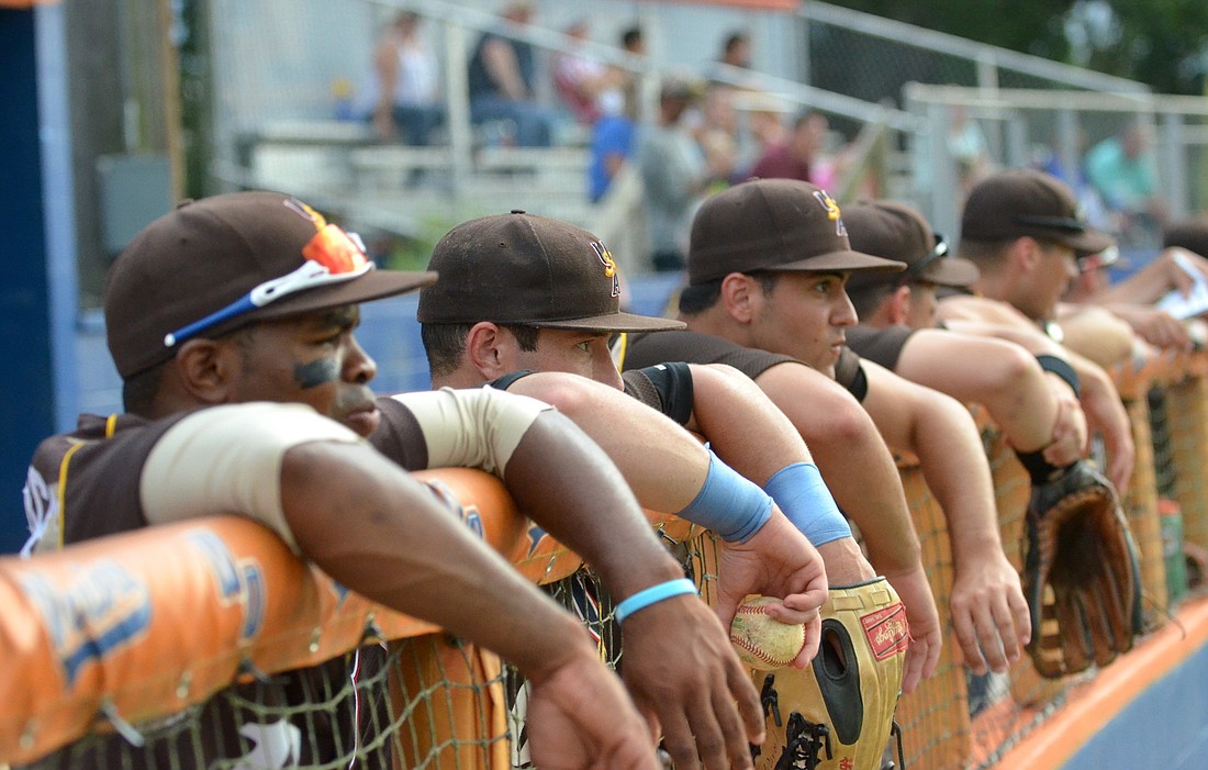 Members of the United States Military All-Stars watch as a teammate is at-bat.