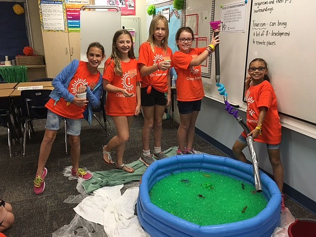 Left to right: Danielle Fleming, Julia Jordan, Mia Travis, Jillian Kuhn and Lilyanna Rosa test their water slide prototype during Windermere Elementary School's  STEM camp called Camp Invention.