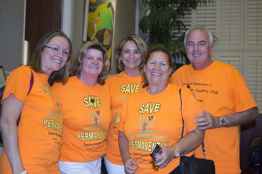 Sarah Moody, Leigh Ann Dyal, Carol Novack, Joanne Matinrazm and Bob Kade wore orange shirts a show of solidarity regarding an issue involving a developerâ€™s request to add more homes to the Windermere Country Club.