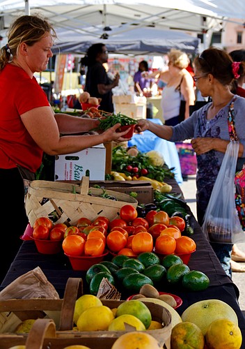 Charissa Ward, left, stocked her stall with locally grown fruits and vegetables that attracted a steady stream of shoppers all morning.