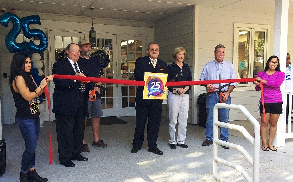 Volunteers hold the ribbon for the officials, Windermere Town Council Members Al Pichon and Bob McKinley, Mayor Gary Bruhn, OCLS Director Mary Anne Hodel and Frank Chase. The event celebrated the 25th anniversary of the Franklin W. Chase Memorial Library.