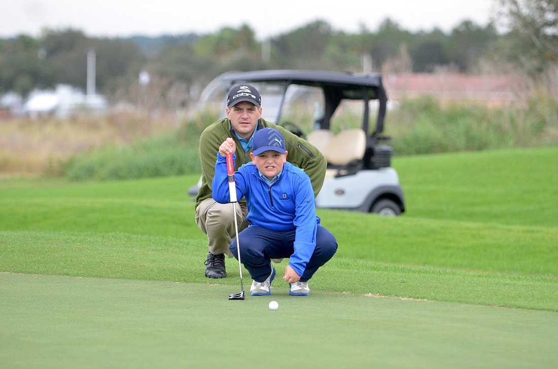 Kiddie Kaddie client Aaron Dewitt receives instruction on the course from director of instruction Michael McMillan.
