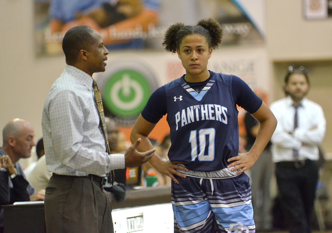 Pictured here chatting with head coach Anthony Jones during a game against Olympia earlier this season, senior guard Tiffany Tolbert set a program record with 41 points in one game Dec. 31.