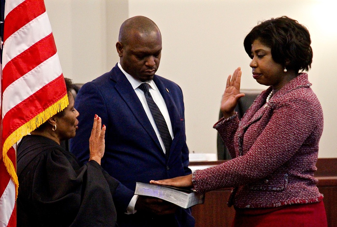 Rep. Kamia Brown took her oath of office during a ceremony on Jan. 5. Sen. Randolph Bracy, who was also sworn in, holds the Bible.