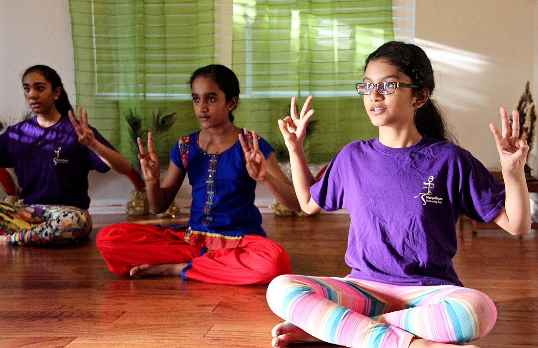 Sahiti Yandapalli, right, practices dance poses  with her classmates to prepare for the schoolâ€™s upcoming annual recital.