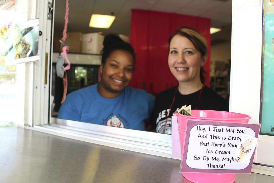 Britney Bouknight (left) and Sweet Jessieâ€™s Ice Cream Shop owner Jessica Pollack stand at the shopâ€™s order window.