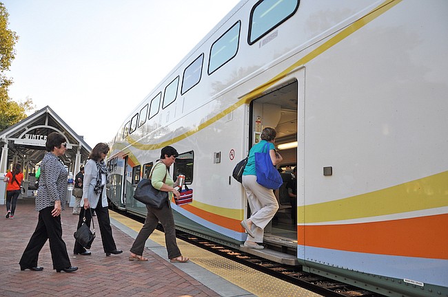 Photo by: Tim Freed - Passengers board a northbound SunRail train in Winter Park Tuesday. The rail system has proven more popular on the weekend.