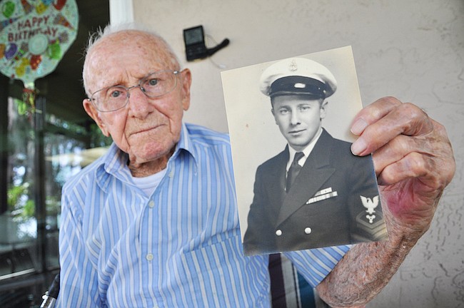 Photo by: Tim Freed - Elmer Brown served 30 years in the Navy, traveling the globe, surviving air raids, and even meeting the Pope. At 100 years old, he's now settled in Winter Park where he lives with his son.