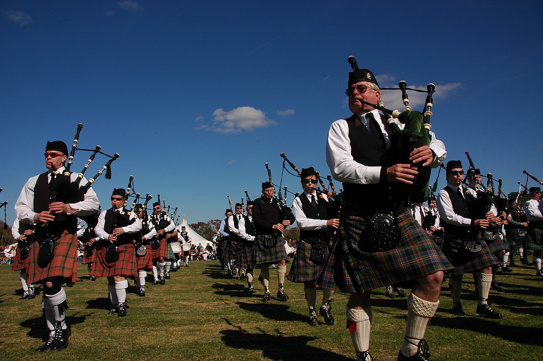 Photo by: Isaac Babcock - Bagpipers march in tandem and belt out Scottish-flavored music at last year's Highland Games festival. The event features cultural food such as meat pies and haggis.