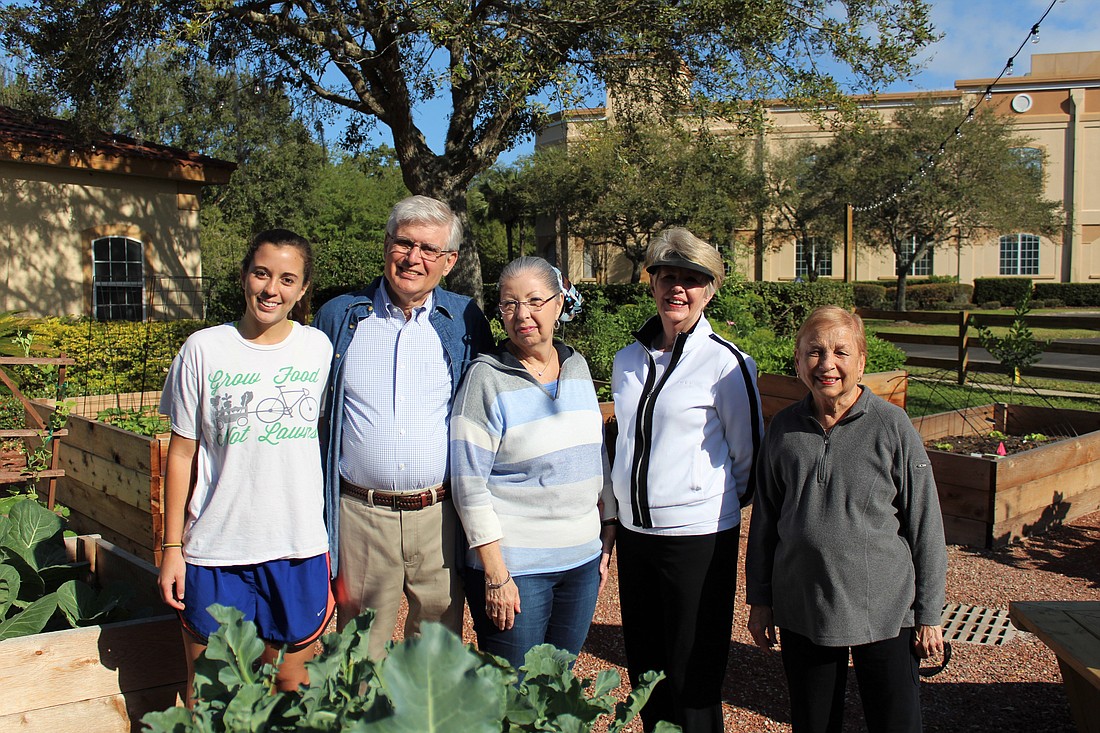 Photo by: Kristen Fiore - Rollins College students join together with Mayflower residents in their community garden.