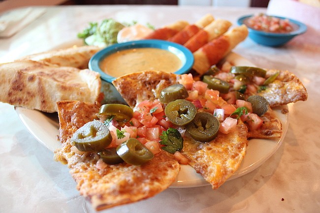 Photo by: Sarah Wilson - Chuy's appetizer plate is enough to share, and pairs perfectly with a margarita. But don't forget to save room for dessert, their flan is the best this reviewer's ever had.