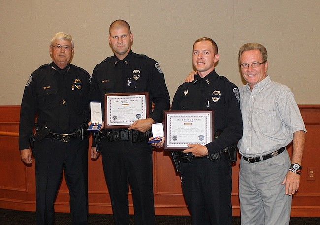 Photo courtesy of city of Maitland - Police officers Joshua Rotarius and Corry Dibiase (center) were both recognized recently for their bravery and service in response to the Pulse nightclub shooting, receiving the Life Saving Award from Maitland Poli...