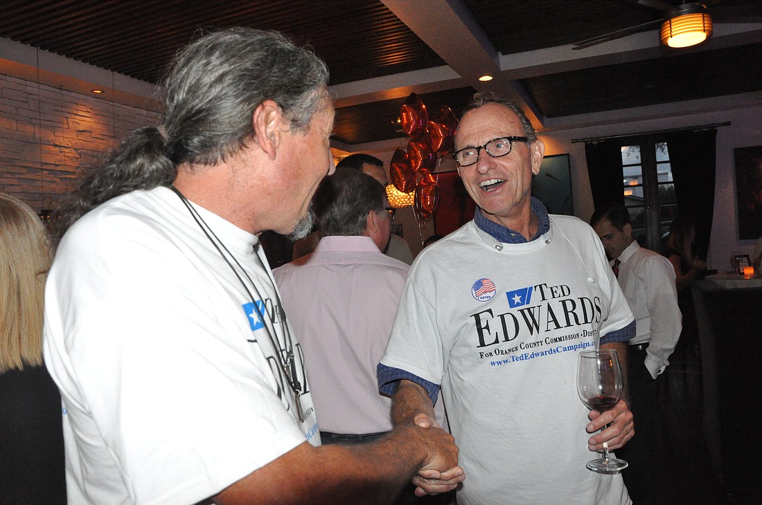 Photo by: Tim Freed - Orange County District 5 Commissioner Ted Edwards shakes hands with a supporter after winning enough votes Tuesday night to move on to a runoff election in November.