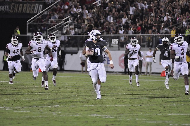 Photo by: Isaac Babcock - Knights quarterback McKenzie Milton outran the Temple Owls on this 2nd quarter 63-yard touchdown run, but the Knights couldn't outrun a come-from-behind loss on the game's  nal drive Saturday.