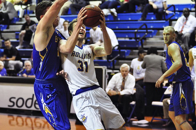 Photo by: Isaac Babcock - Rollins' Sam Philpott fights his way to the basket against Embry-Riddle on Feb. 1.