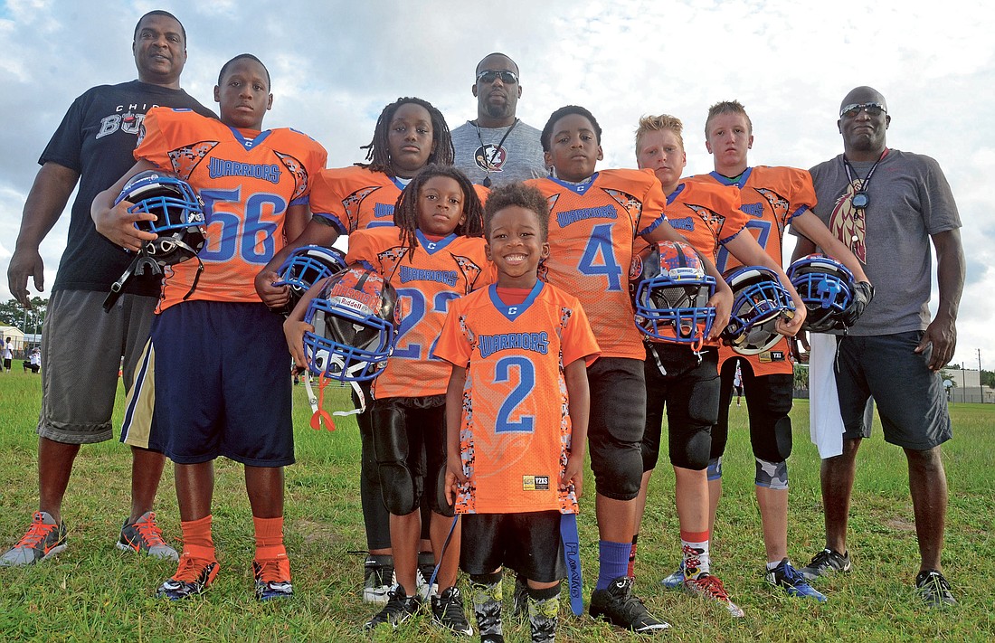 Junior Warriors players Luther Johnson, left, Trillshun Bacon, Moses Ward, Khalil Thomas, Sean Turner, Joey McCann and Tyson Schwalbach enjoy being coached by former NFL players such as Sam Williams, left, Julian Pittman and William Floyd.