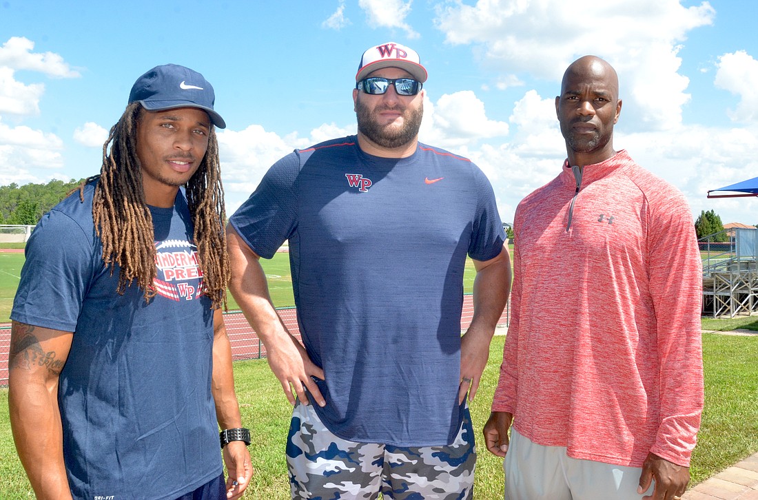 Andre Martin, Mike McGlynn and Brian Simmons are helping coach the varsity football team at Windermere Prep this fall.