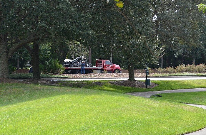Workers prepared to tow remnants of the vehicle just before noon.