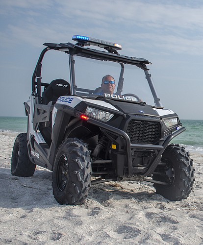 Sgt. David Cooper patrols the beach on the north end of the island in the Longboat Key Police Department&#39;s all-terrain vehicle.