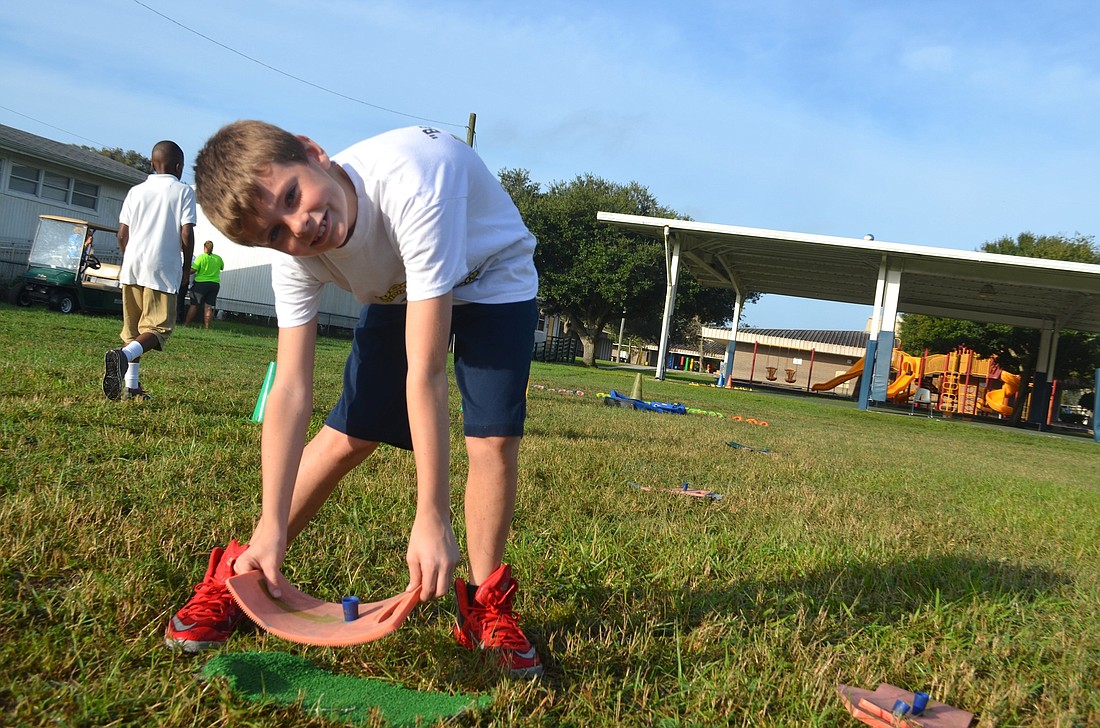 Kaden Daft, 10, last week started helping physical education teacher Melissa Dowling set up for her classes.
