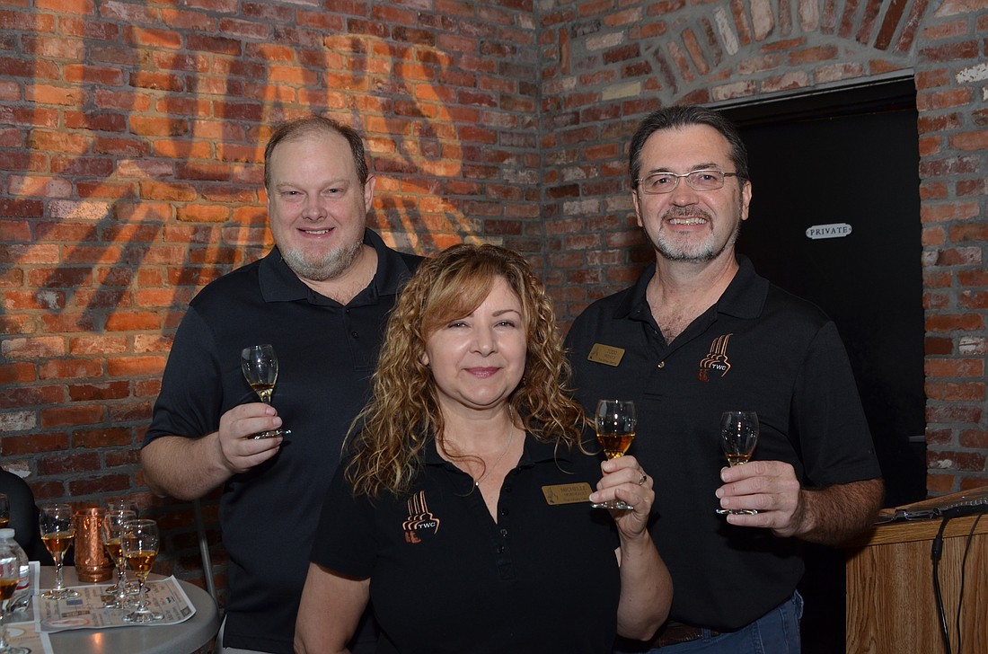 Art McIntosh, left, Michelle Morneault and Todd Nichols are three of the five leaders of the Central Florida Malt Whisky Cabinet.