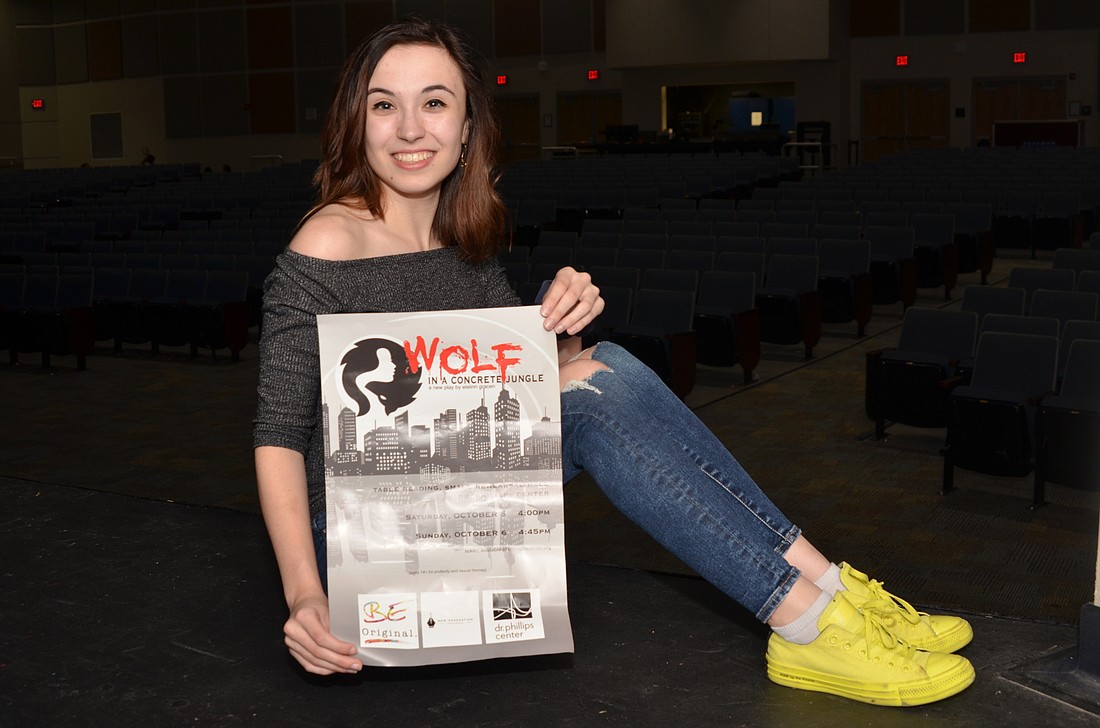Eislinn Gracen received a poster promoting her play, â€œWolf in a Concrete Jungle,â€ which was one of 16 winners in a theater festival contest.