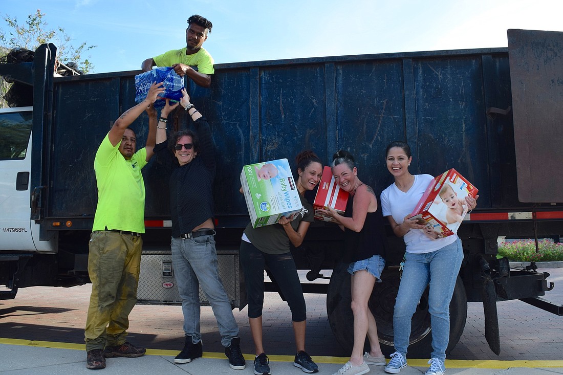 It was a hot, sweaty job, but volunteers at Runway to Hope and XL 106.7â€™s supplies drive were happy to help.