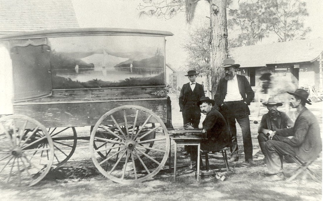 A traveling jewelry salesman made a stop at the corner of Woodland and Plant streets, around 1908. G.W.B. Bray stands next to the seated salesman, and J.L. Dillard stands to his right. At the far right is Bob Dillard.