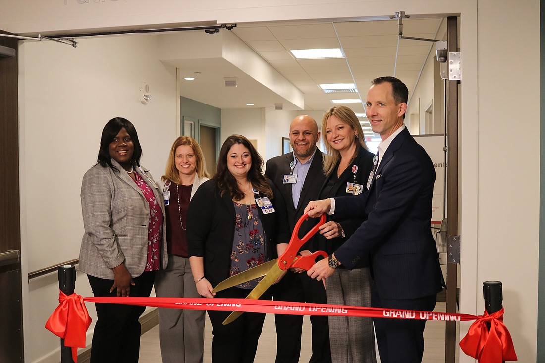 Orlando Health officials cut the ribbon to celebrate the opening of the new space at the fifth floor of Dr. P. Phillips Hospital.
